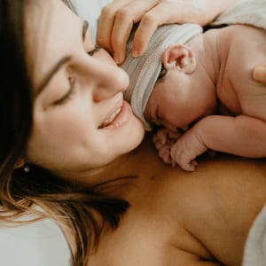 new parent holding baby skin to skin